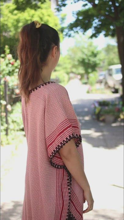 Derya walking around in a red matia kaftan